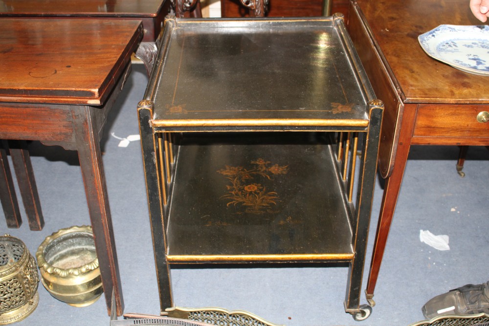 A 1920s black lacquered two tier trolley, with gilt floral decoration, W.63cm D.55cm H.71cm